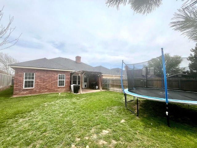 8400 El Paso Dr, Amarillo, TX 79118 - view of yard with a patio, a trampoline, a pergola, and a fenced backyard