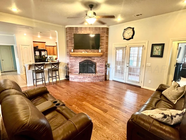 8400 El Paso Dr, Amarillo, TX 79118 - living room with a fireplace, light wood-style flooring, ornamental molding, and ceiling fan