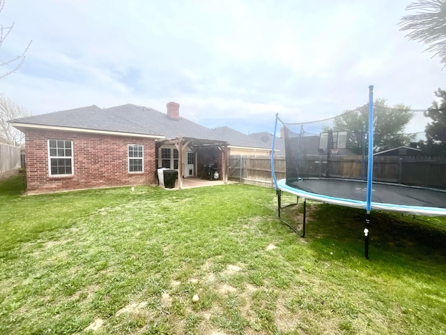 8400 El Paso Dr, Amarillo, TX 79118 - view of yard with fence, a trampoline, a patio, and a pergola