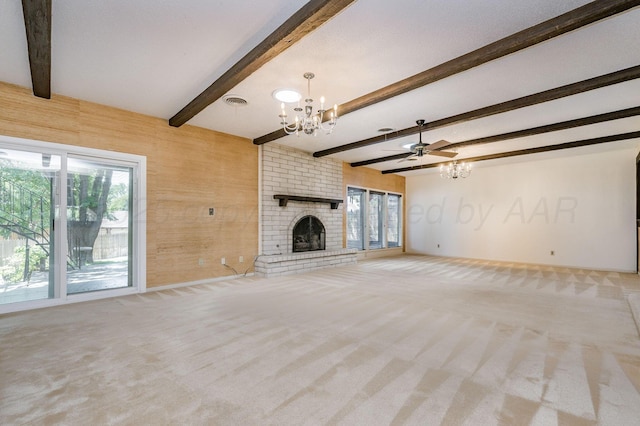 unfurnished living room with a fireplace, ceiling fan with notable chandelier, light colored carpet, beamed ceiling, and wood walls