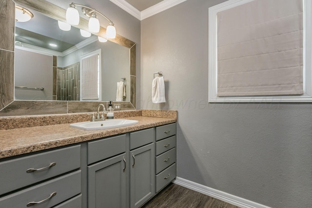 bathroom featuring crown molding, hardwood / wood-style floors, and vanity