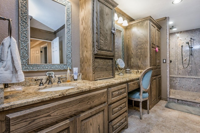 bathroom featuring vanity, a shower, and lofted ceiling