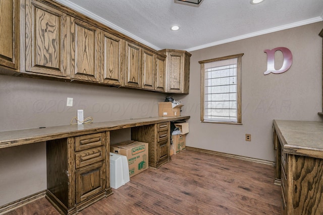 home office featuring a textured ceiling, dark hardwood / wood-style floors, and ornamental molding