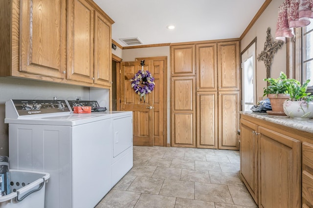 laundry area with cabinets, independent washer and dryer, and crown molding