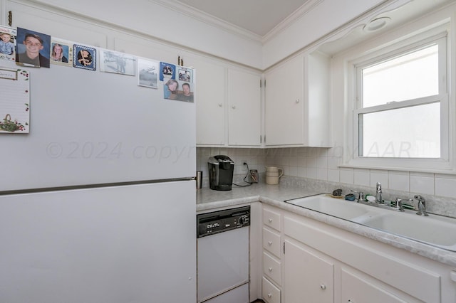 kitchen featuring white cabinetry, sink, backsplash, white appliances, and crown molding