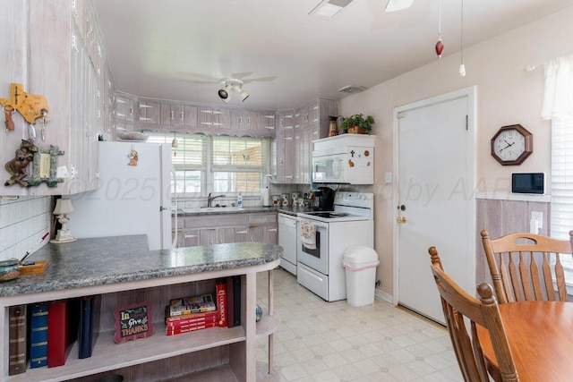 3406 Meadow Dr, Amarillo, TX 79109 - kitchen with white appliances, open shelves, a ceiling fan, light floors, and dark countertops
