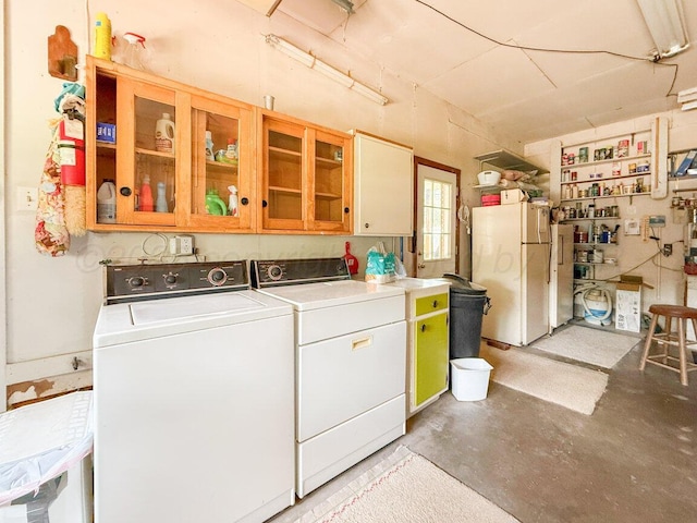 3406 Meadow Dr, Amarillo, TX 79109 - laundry room featuring washing machine and clothes dryer and cabinet space