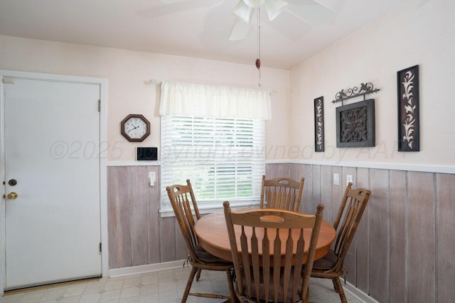 3406 Meadow Dr, Amarillo, TX 79109 - dining space featuring a ceiling fan, wooden walls, light floors, and wainscoting