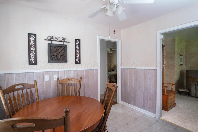3406 Meadow Dr, Amarillo, TX 79109 - dining room featuring a ceiling fan, a wainscoted wall, and light floors