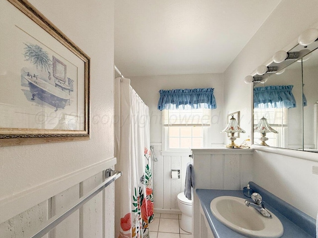 3406 Meadow Dr, Amarillo, TX 79109 - bathroom featuring vanity, tile patterned floors, a shower with shower curtain, and wainscoting