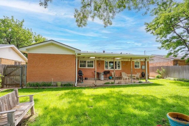 3406 Meadow Dr, Amarillo, TX 79109 - rear view of house with brick siding, a fenced backyard, a patio, and a gate
