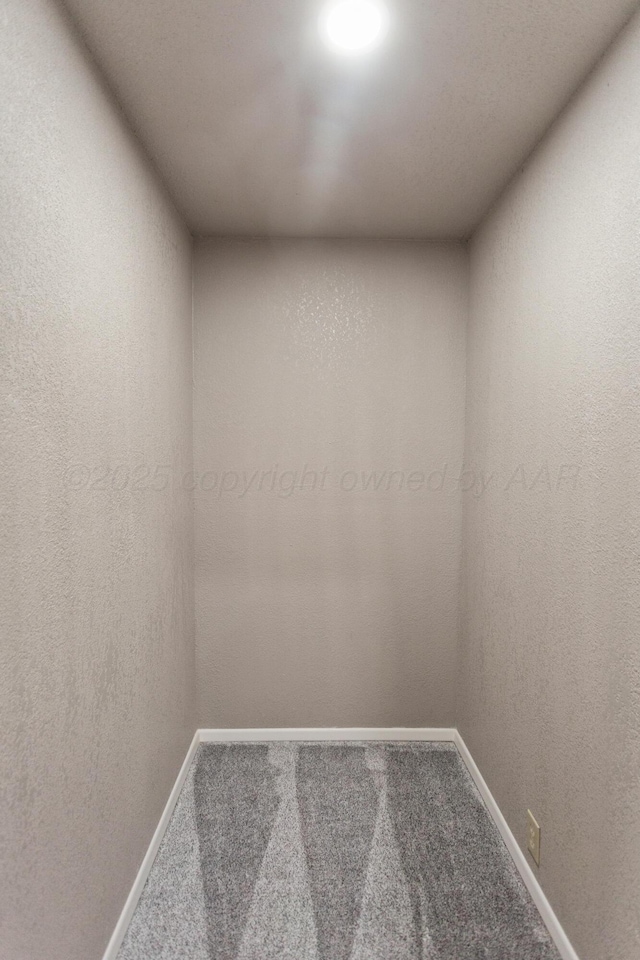 carpeted spare room with baseboards