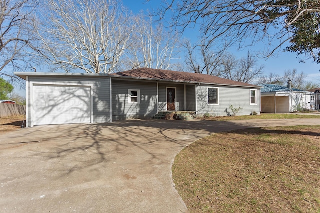 single story home with a front yard, concrete driveway, and an attached garage