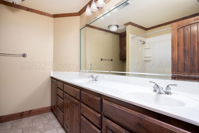 bathroom with a sink, visible vents, baseboards, and double vanity