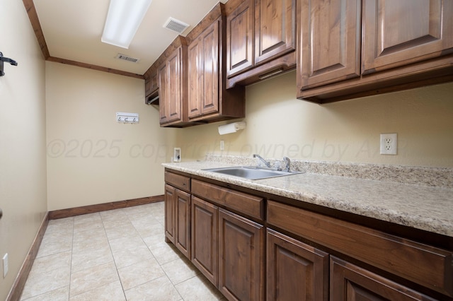 kitchen featuring light countertops, visible vents, and a sink