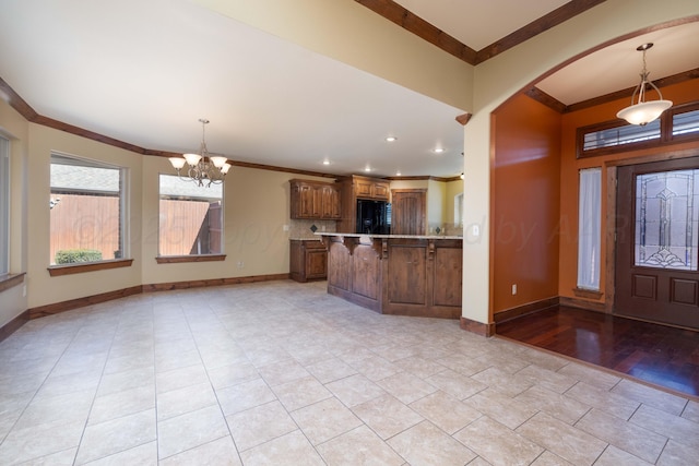 foyer entrance with recessed lighting, baseboards, a chandelier, and crown molding