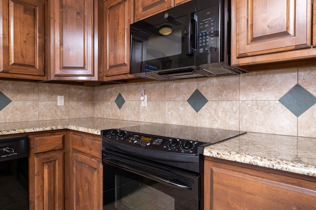 kitchen featuring tasteful backsplash, black appliances, brown cabinetry, and light stone countertops