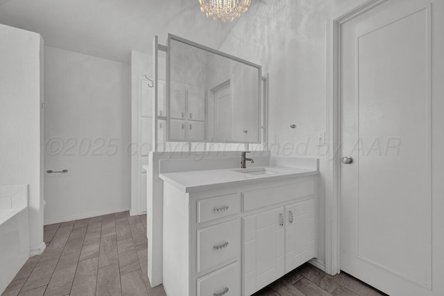 full bathroom with wood tiled floor, a notable chandelier, vanity, and a bath