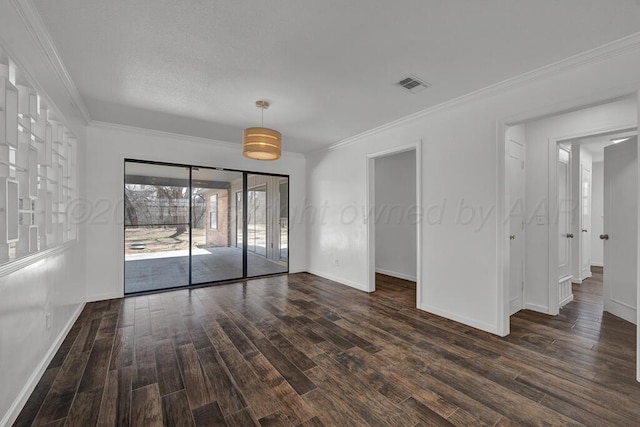 unfurnished room featuring ornamental molding, dark wood finished floors, visible vents, and baseboards