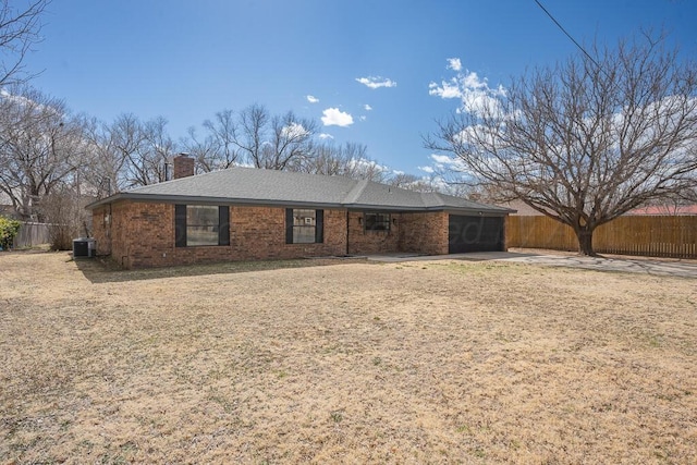 view of front of home featuring a garage, a chimney, fence, central AC, and brick siding