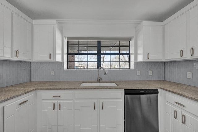 kitchen featuring dishwasher, tasteful backsplash, a sink, and white cabinets