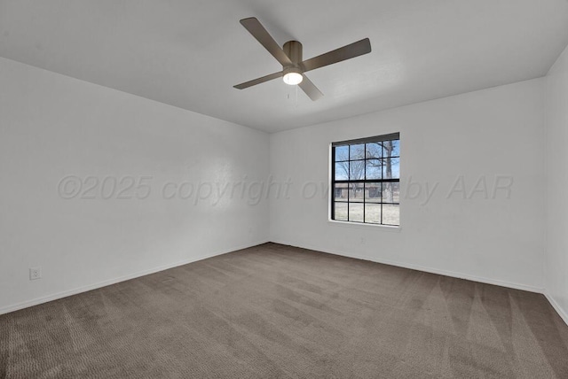 spare room with ceiling fan, baseboards, and dark colored carpet