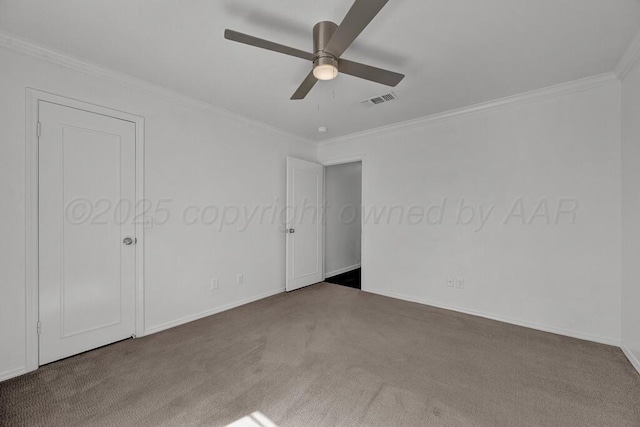 unfurnished bedroom with baseboards, carpet, visible vents, and crown molding