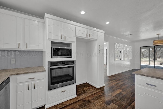 kitchen featuring recessed lighting, stainless steel appliances, white cabinetry, backsplash, and dark wood finished floors