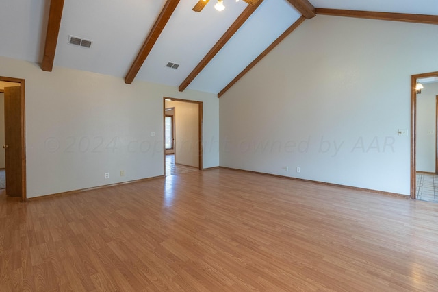 empty room with light wood-type flooring, beam ceiling, and high vaulted ceiling