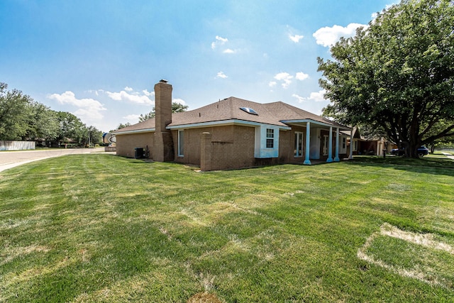 back of property featuring a lawn