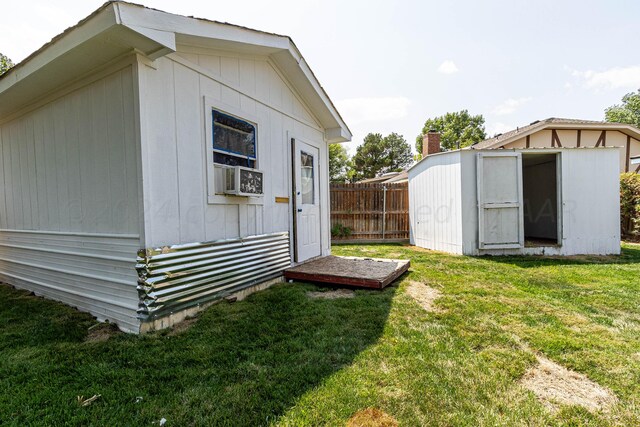 exterior space with a yard and a storage unit