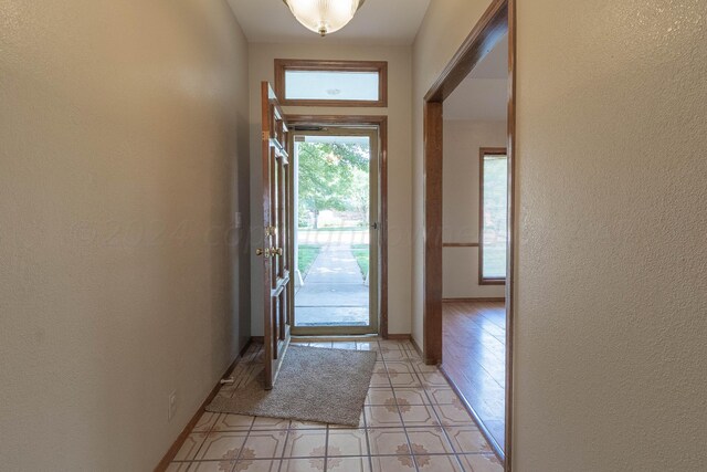 entryway with light tile patterned flooring