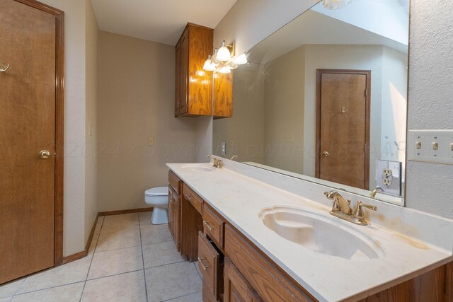 bathroom featuring toilet, vanity, and tile patterned floors