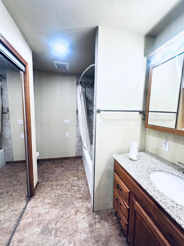 full bathroom with vanity, a textured ceiling, toilet, and shower / bathtub combination with curtain