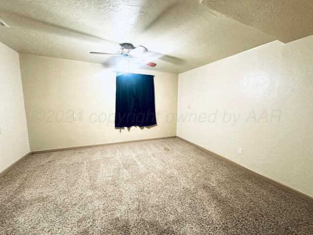 unfurnished room with ceiling fan, a textured ceiling, and carpet floors