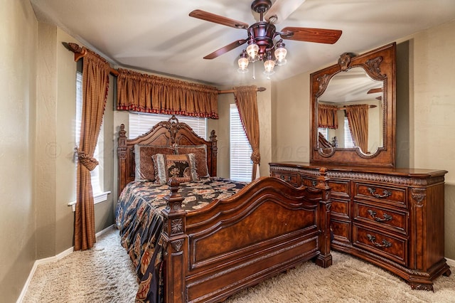 1204 University Pl, Borger, TX 79007 - bedroom with light carpet, baseboards, and a ceiling fan