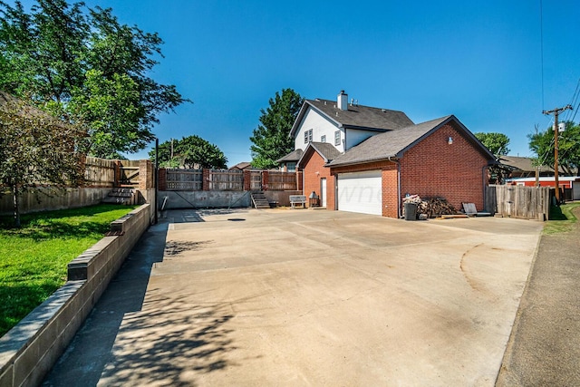 1204 University Pl, Borger, TX 79007 - view of side of property with brick siding, a garage, and driveway