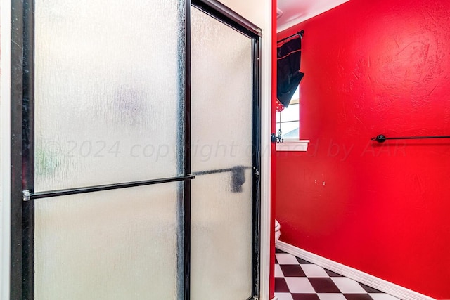 1204 University Pl, Borger, TX 79007 - bathroom featuring tile patterned floors, a shower stall, toilet, and baseboards
