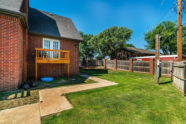 1204 University Pl, Borger, TX 79007 - view of yard with a trampoline and a deck