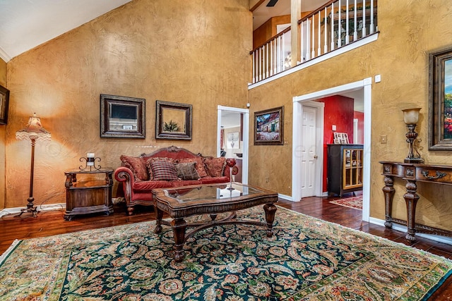 1204 University Pl, Borger, TX 79007 - living room with hardwood / wood-style floors, baseboards, a towering ceiling, and a textured wall