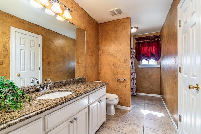 1204 University Pl, Borger, TX 79007 - bathroom featuring vanity, toilet, tile patterned floors, and baseboards