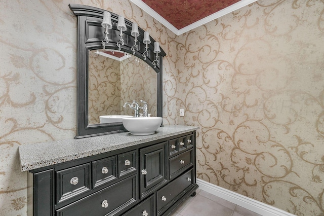 7723 Stuyvesant Ave, Amarillo, TX 79121 - bathroom featuring wallpapered walls, ornamental molding, vanity, tile patterned flooring, and baseboards