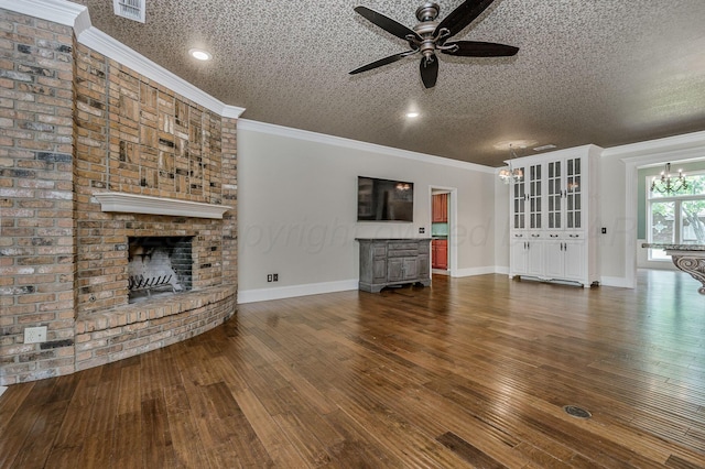7723 Stuyvesant Ave, Amarillo, TX 79121 - unfurnished living room with a ceiling fan, a brick fireplace, dark wood-type flooring, crown molding, and a textured ceiling