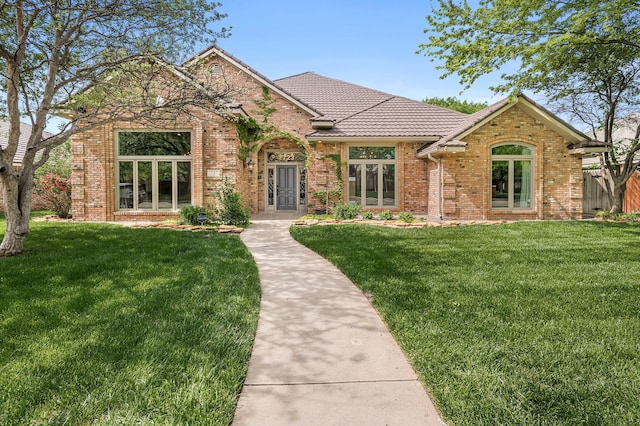 7723 Stuyvesant Ave, Amarillo, TX 79121 - view of front of home featuring brick siding and a tiled roof