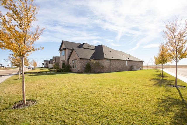 5609 Hollow Landing Ave, Amarillo, TX 79118 - view of property exterior featuring a yard and brick siding