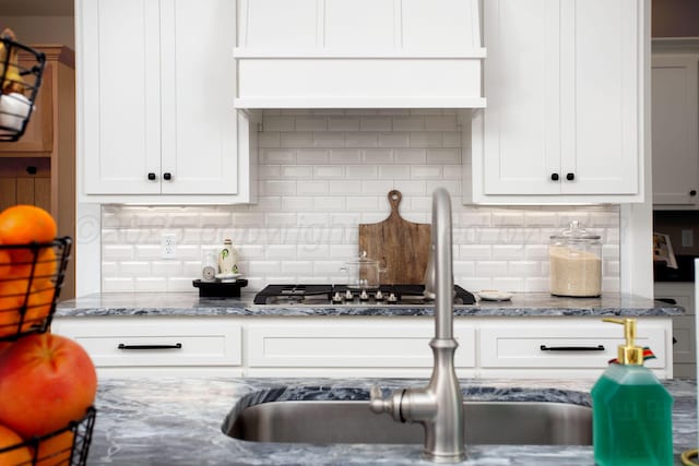 5609 Hollow Landing Ave, Amarillo, TX 79118 - kitchen with light stone countertops, backsplash, and white cabinetry
