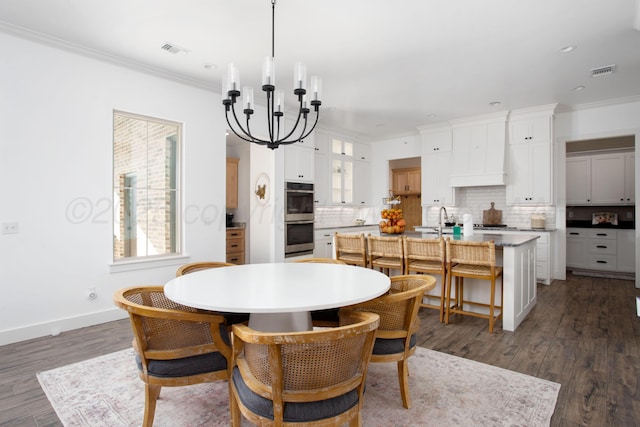 5609 Hollow Landing Ave, Amarillo, TX 79118 - dining space with a chandelier, crown molding, dark wood-type flooring, baseboards, and recessed lighting