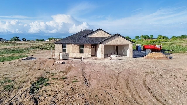 rear view of property with stone siding