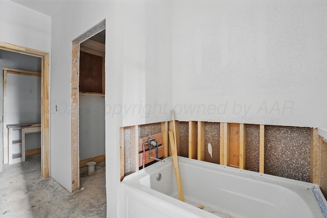 bathroom featuring a tub and concrete flooring