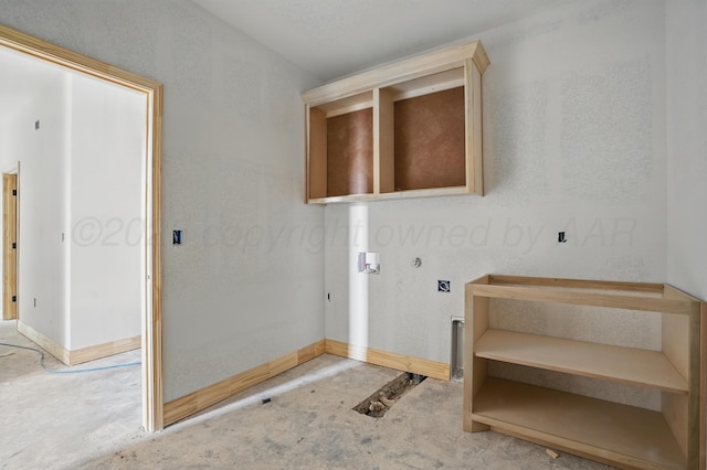 laundry room with baseboards